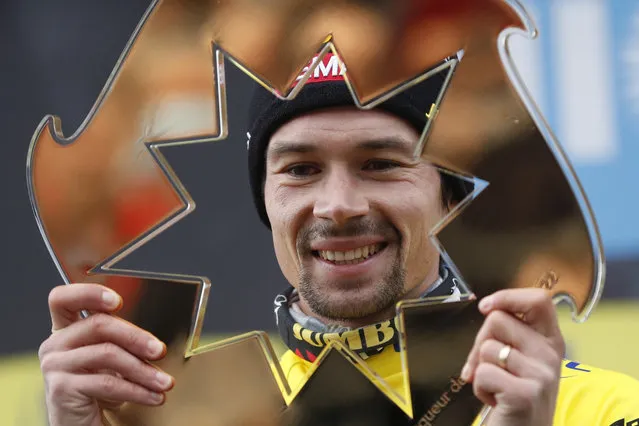 Slovenian rider Primoz Roglic of Jumbo Visma celebrates on the podium holding the trophy after winning the Paris-Nice cycling race, in Nice, southern France, Sunday, March, 13, 2022. (Photo by Jean Francois Badias/AP Photo)