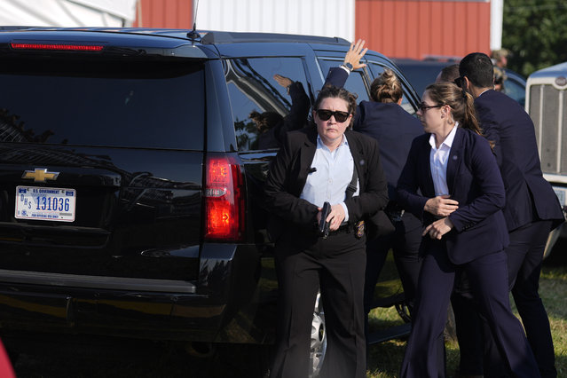 The vehicle carrying Republican presidential candidate former President Donald Trump is surrounded by U.S. Secret Service agents at a campaign rally, Saturday, July 13, 2024, in Butler, Pa. (Photo by Evan Vucci/AP Photo)