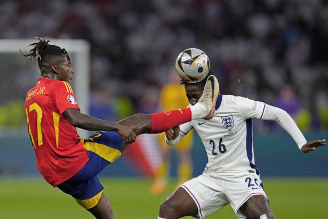 Spain's Nico Williams reaches for the ball in front of England's Kobbie Mainoo during the final match between Spain and England at the Euro 2024 soccer tournament in Berlin, Germany, Sunday, July 14, 2024. (Photo by Manu Fernandez/AP Photo)