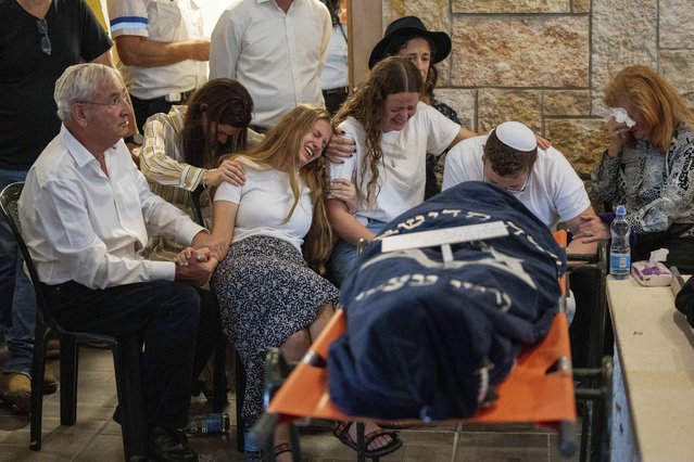 Mourners attend the funeral of two British-Israeli sisters, Maia and Rina Dee, at a cemetery in the West Bank Jewish settlement of Kfar Etzion, Sunday, April 9, 2023. The two sisters were killed in a shooting attack on Friday by Palestinian gunmen in the West Bank. (Photo by Ohad Zwigenberg/AP Photo)