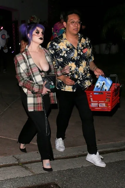 TV Personality, Kelly Osbourne and a friend leave Paris Hilton's Halloween Party in Beverly Hills, CA. on October 24, 2019. Kelly rocked her iconic purple hair with s*xy clown makeup and dressed in a flannel and black pants. (Photo by Backgrid USA)