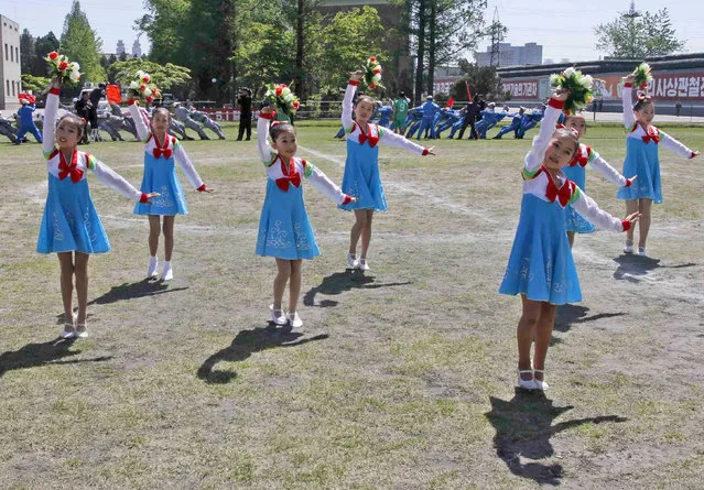 North Korean children perform at a celebration of May Day at the Pyongyang Thermal Power Complex in Pyongyang, North Korea, Monday, May 1, 2017. (Photo by Jon Chol Jin/AP Photo)
