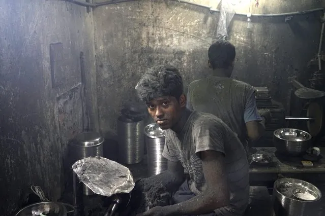Sohel Rana polishes a pot at an aluminium factory in Dhaka, Bangladesh, 25 May 2016. He earns around 100 euro per month working more than 12 hours a day. Many young workers migrated to the city for a better job and live in slums without families. (Photo by Abir Abdullah/EPA)