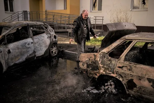 A man looks at his burned car after a Russian attack in Kharkiv, Ukraine, Friday, April 15, 2022. (Photo by Felipe Dana/AP Photo)
