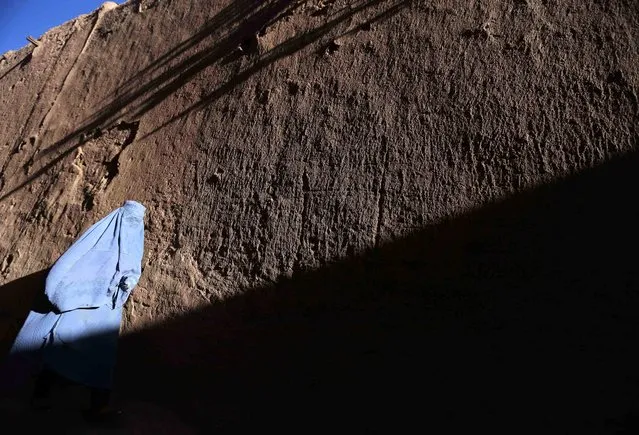 An Afghan woman wearing traditional dress walks along a street in Herat, Afghanistan, 30 May 2016. Although Afghanistan's economy has reportedly improved, the country still relies on foreign aid for more than 90 per cent of national income, and ongoing unrest which has increased with the partial withdrawal of foreign troops January 2015 has further damaged potential for economic growth. (Photo by Jalil Rezayee/EPA)