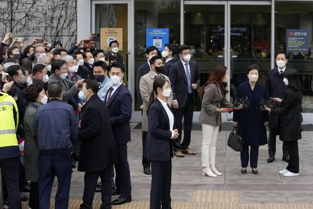Former South Korean President Park Geun-hye, third from right, speaks as she leaves the Samsung Medical Center for a home in Seoul, South Korea, Thursday, March 24, 2022. Three months after receiving a pardon over one of South Korea’s worst government-corruption scandals, former President Park was finally going home on Thursday, following her release from a hospital in capital Seoul. (Photo by Lee Jin-man/AP Photo)