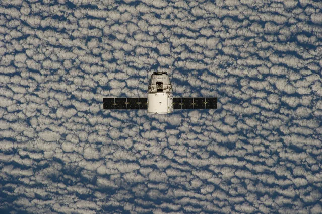 This photo provided by NASA is one of an extensive series of still photos documenting the arrival and ultimate capture and berthing of the SpaceX Dragon capsule at the International Space Station, as photographed by the Expedition 39 crew members onboard the orbital outpost Sunday April 20, 2014. (Photo by AP Photo/NASA)