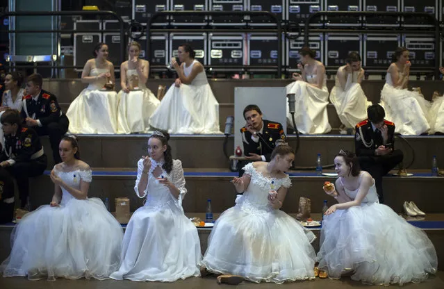 Participants of a ball for students of military schools sit backstage during an annual ball in Moscow, Russia, Tuesday, December 11, 2018. In the revival of a czarist tradition, more than 1,000 students both from military and general schools travelled from all over Russia to Moscow to take part in the annual ball. (Photo by Alexander Zemlianichenko/AP Photo)