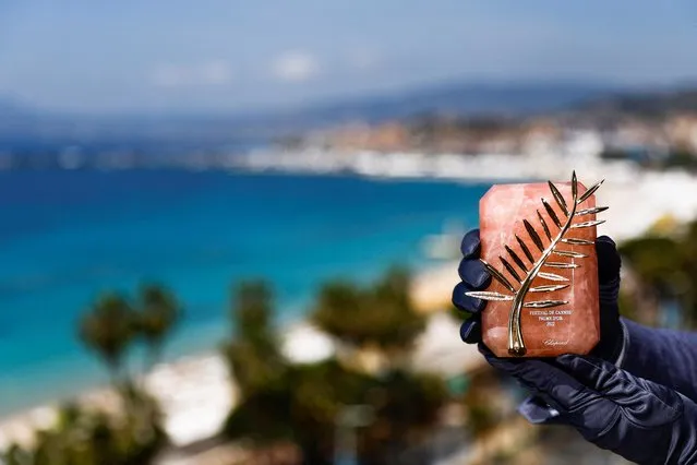 A Chopard representative displays an exceptional Palme d'Or, the highest prize awarded to competing films, created for the 75th anniversary of the Cannes Film Festival, during an interview on the day of the opening ceremony of the festival in Cannes, France on May 17, 2022. (Photo by Stephane Mahe/Reuters)