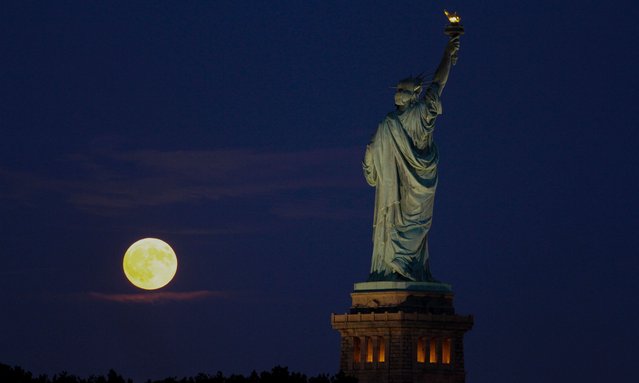 The supermoon, known as the harvest moon in the northern hemisphere, rises behind the Statue of Liberty in New York on September 18, 2024. (Photo by Deccio Serrano/NurPhoto/Rex Features/Shutterstock)