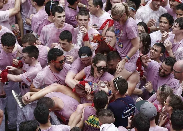 Revellers crowd Consistorio square moments before the rocket fire or “Txupinazo” marks the start of the Festival of San Fermin (or Sanfermines) in Pamplona, Spain, 06 July 2014. The annual nine day long running-with-the-bulls fiesta commemorates St. Fermin, Pamplona's patron saint. (Photo by Javier Lizin/EFE)
