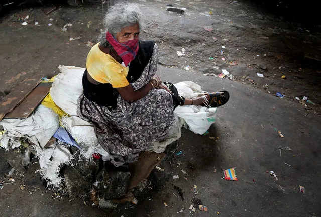 An elderly woman looks on in Bangalore, India, 17 June 2016. According to Indian 2011 Census data released in June 2016, India has more than 1.17 crore people over the age of 70 who are still working to earn their daily needs. The majority of the elderly working population is from the rural areas and does hard physical labors. (Photo by Jagadeesh N.V./EPA)