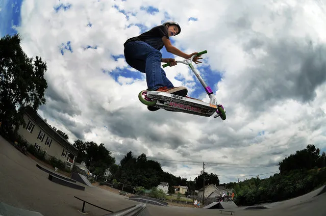 Brandon Franchak, 13, of Carbondale, Pa., glides in the warm summer air on his scooter Thursday, July 10, 2014, at Carbondale Skate Park in Carbondale, Pa. (Photo by Butch Comegys/AP Photo/The Scranton Times-Tribune)