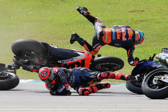 Australian rider Jack Miller (on tarmac) of Red Bull KTM Factory Racing and teammate Brad Binder of South Africa fall after a crash during the Malaysia Motorcycling Grand Prix 2024 at the Petronas Sepang International Circuit, in Sepang, Malaysia, 03 November 2024. (Photo by Fazry Ismail/EPA)