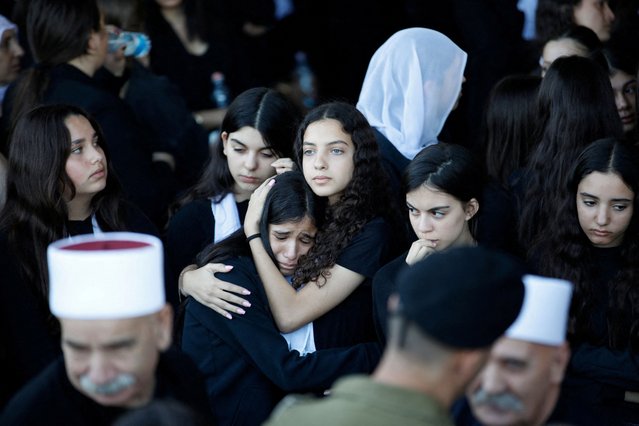 People mourn Colonel Ehsan Daxa, who was killed amid the ongoing conflict in Gaza between Israel and Hamas, during his funeral in the Druze village of Daliyat al-Karmel, Israel, on October 21, 2024. (Photo by Shir Torem/Reuters)