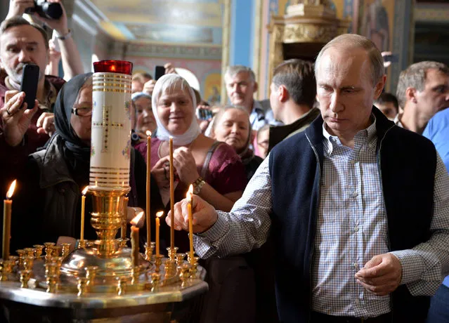 Russian President Vladimir Putin attends a religious service at the Cathedral of the Transfiguration of the Savior at Valaam Monastery, Russia, July 11, 2016. (Photo by Alexei Druzhinin/Reuters/Sputnik/Kremlin)