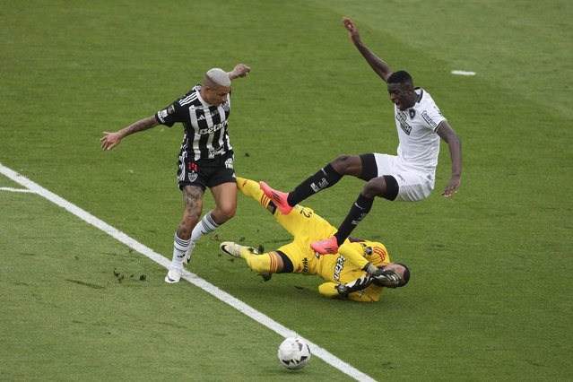 Luiz Henrique of Brazil's Botafogo, right. is fouled by goalkeeper Everson of Brazil's Atletico Mineiro inside the penalty area during a Copa Libertadores final soccer match at Monumental stadium in Buenos Aires, Argentina, Saturday, November 30, 2024. (Photo by Natacha PisarenkoAP Photo)