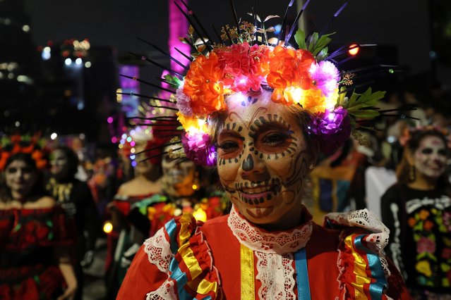 People dressed as “Catrinas” parade through the streets during celebrations ahead the Day of the Dead in Mexico City, Sunday, October 27, 2024. (Photo by Ginnette Riquelme/AP Photo)