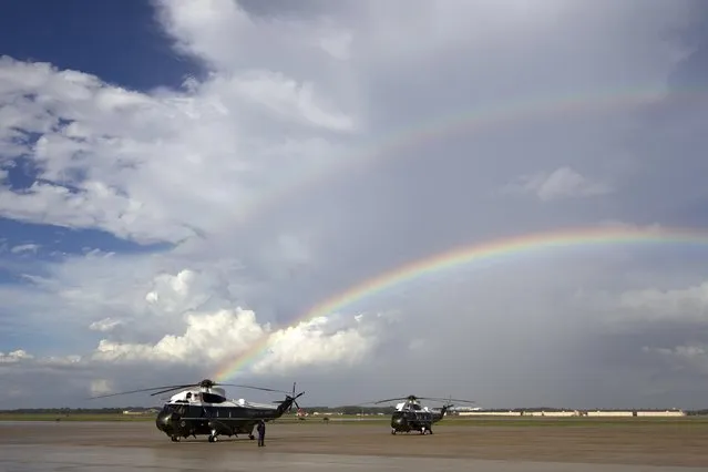 A rainbow appears over Marine One minutes before President Barack Obama landing at Andrews Air Force Base, Md., Monday, September 1, 2014. (Photo by Jose Luis Magana/AP Photo)