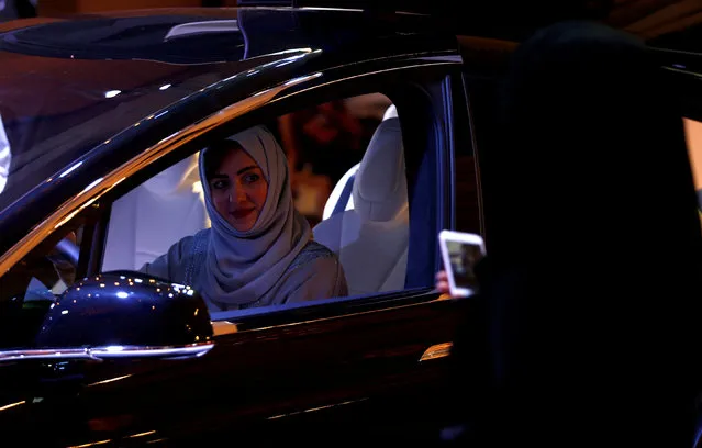 A Saudi woman is photographed as she checks a car at a showroom in Riyadh, Saudi Arabia October 5, 2017. (Photo by Faisal Al Nasser/Reuters)