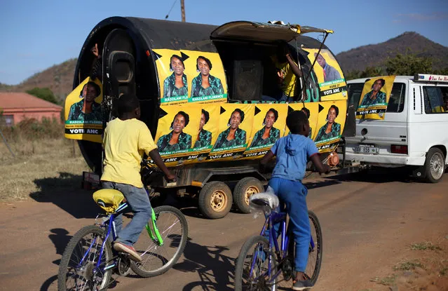 Boys ride their bicycles behind a trailer with ANC posters of a local ward councilor ahead of tommorow's local munincipal elections in Vuwani, South Africa's northern Limpopo province, August 2, 2016. (Photo by Siphiwe Sibeko/Reuters)