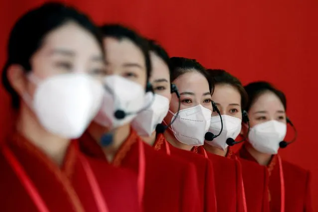 Staff members, wearing face masks following the coronavirus disease (COVID-19) outbreak, stand at an exhibition titled “Forging Ahead in the New Era” during an organised media tour ahead of the 20th National Congress of the Communist Party of China, in Beijing, China on October 12, 2022. (Photo by Florence Lo/Reuters)