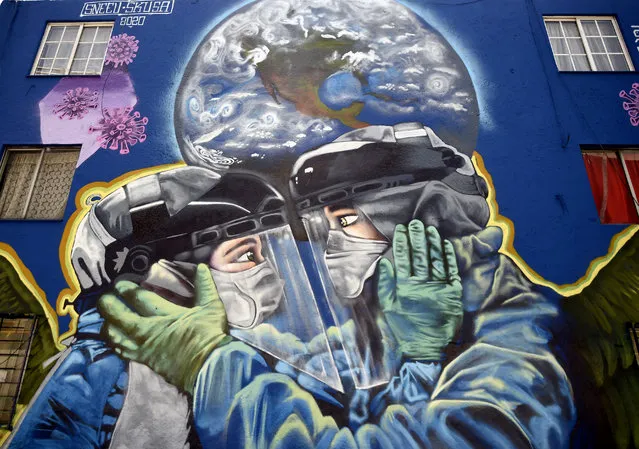 View of a coronavirus-related mural at the San Miguel Chapultepec neighborhood in Mexico City, on June 9, 2020, during the novel COVID-19 pandemic. (Photo by Alfredo Estrella/AFP Photo)