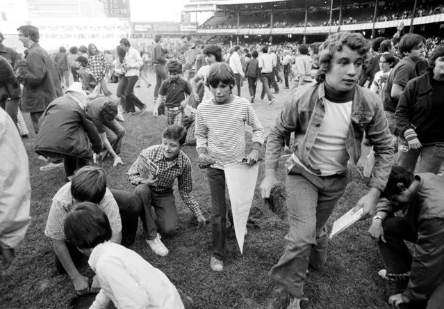 Fans attempt to take apart Yankee Stadium in New York City, on the last day of the season, September 30,1973. It was the last day of the old stadium, in use since 1923, prior to renovation which should take at least two years. (Photo by Richard Drew/AP Photo)