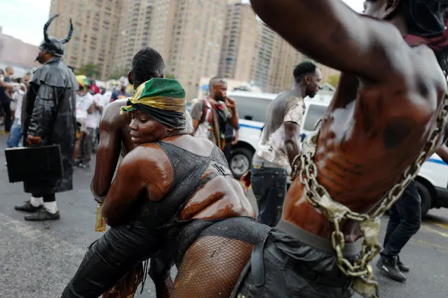 Revellers covered in oil dance during the overnight-into-dawn celebration called J'Ouvert, ahead of the annual West Indian-American Carnival Day Parade in Brooklyn, NY, U.S. September 5, 2016. (Photo by Mark Kauzlarich/Reuters)