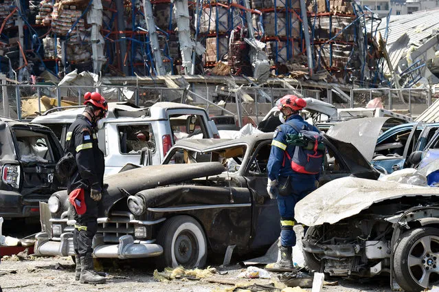 Greek rescue workers search amid the rubble three days after explosions that hit Beirut port, in Beirut, Lebanon, 07 August 2020. According to the Lebanese Health Ministry, at least 137 people were killed, and more than 5,000 injured in the blast believed to have been caused by an estimated 2,750 tons of ammonium nitrate stored in a warehouse. The explosion and its shockwave on 04 August 2020 devastated the port area. (Photo by Wael Hamzeh/EPA/EFE)