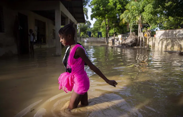A girl wades towards her flooded home the day after the passing of Tropical Storm Laura in Port-au-Prince, Haiti, Monday, August 24, 2020. Laura battered the Dominican Republic and Haiti on it's way to the U.S. Gulf Coast, where forecaster fear it could become a major hurricane. (Photo by Dieu Nalio Chery/AP Photo)