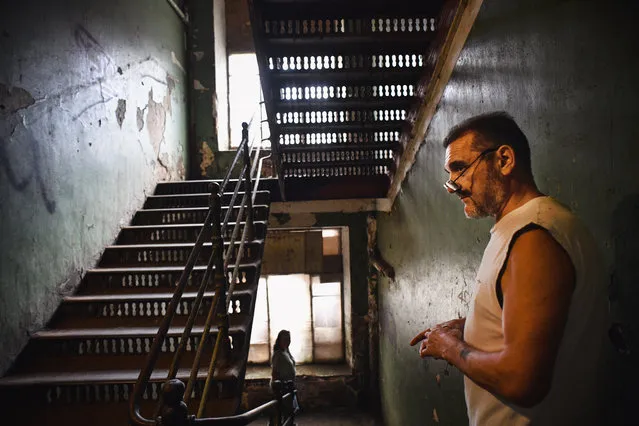 Vladimir Mogilnikov, 62, stands in a stairway in a dormitory for the workers of Proletarka textile factory in the town of Tver, 200 kilometres north-west from Moscow on August 8, 2020. (Photo by Andrey Borodulin/AFP Photo)