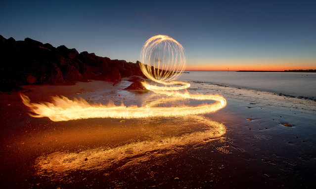 Pictured on December 9, 2022 during the Friday sunset on Martello beach at Clacton in Essex is some light painting with fire created by spinning fire with a 21-second exposure. (Photo by Kevin Jay/Picture Exclusive)
