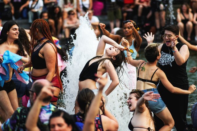People go into the Washington Square fountain as they take part in the NYC Dyke March during New York's Pride week LGBTQ+ celebration in New York City, U.S., June 28, 2025. (Photo by Eduardo Munoz/Reuters)