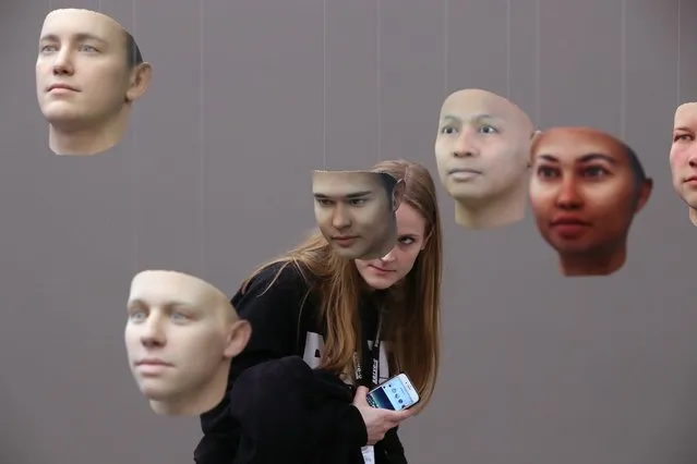 A visitor, who said she did not being photographed, looks at 3D-printed faces of what could be Chelsea Manning according to Manning's DNA in the installation “A Becoming Resemblance” by American artist Heather Dewey-Hagborg at the annual Transmediale art and digital culture show on January 31, 2018 in Berlin, Germany. The thirty masks are derived from Chelsea Manning's DNA, smuggled out of prison when Manning, then Bradley, was serving time for passing classified information to WikiLeaks. (Photo by Sean Gallup/Getty Images)