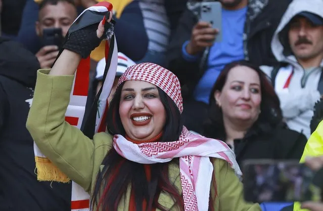 Iraqi soccer fan waves her country flag inside the stadium before the Arabian Gulf Cup football final between Iraq and Oman at the Basra International Stadium in Basra, Iraq, Thursday, January 19, 2023. (Photo by Nabil al-Jurani/AP Photo)