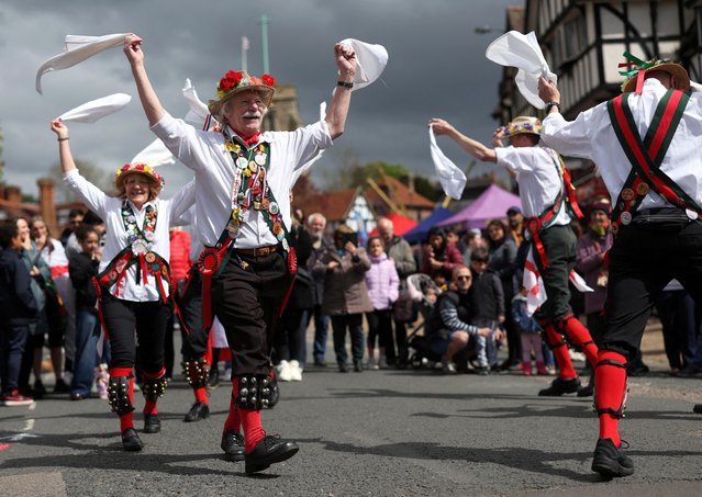 People perform during the St. George's Day celebration in northwest London, Britain, on April 21, 2024. It has been held for the past 61 years as part of the London suburb's St. George's Day celebrations and involves teams of two taking turns pushing each other in a wheelbarrow through the streets of Pinner while drinking beer. (Photo by Suzanne Plunkett/Reuters)
