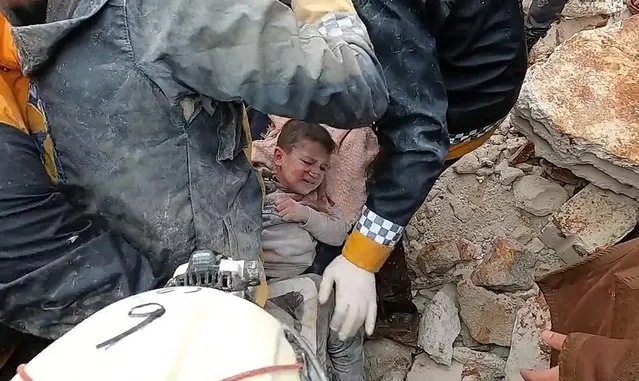 Rescue men evacuate a child pulled out of the rubble following an earthquake in northwestern Syrian Idlib in the rebel-held part of Idlib province, on February 6, 2023. Hundreds have been reportedly killed in Turkey and Syria after a 7.8-magnitude earthquake that originated in Turkey and was felt across Middle East countries. (Photo by Syria Civil Defense/UPI/Rex Features/Shutterstock)