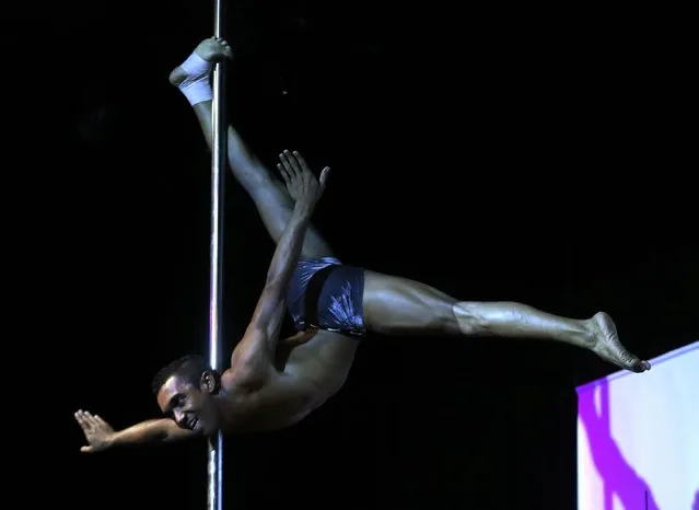 Michel Nascimento of Brazil competes in the South American Pole Dance Championship in Buenos Aires November 24, 2014. (Photo by Enrique Marcarian/Reuters)