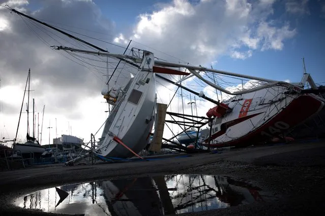 This photograph shows Class 40 ships on the ground, at the Chantereyne port, in Cherbourg, northwestern France, on January 16, 2022, after the storm “Gerard” hit the region. Three French departments are still under orange weather alerts as strong winds are linked to the low-pressure system Gerard, which should lose its intensity this afternoon. (Photo by Lou Benoist/AFP Photo)