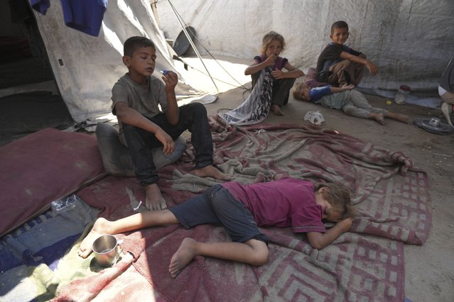 Children from the Sobh family rest inside their tent at a camp for displaced Palestinians in Gaza City, Thursday, July 24, 2025. (Photo by Jehad Alshrafi/AP Photo)