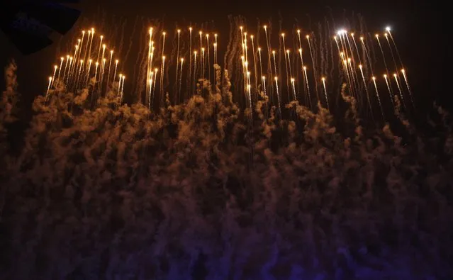 Fireworks explode to form the letters “APEC” above the National Stadium, also known as the “Bird's Nest”, during a lights and fireworks show to celebrate the Asia-Pacific Economic Cooperation (APEC) Leaders' Meeting, in Beijing November 10, 2014. (Photo by Reuters/China Daily)