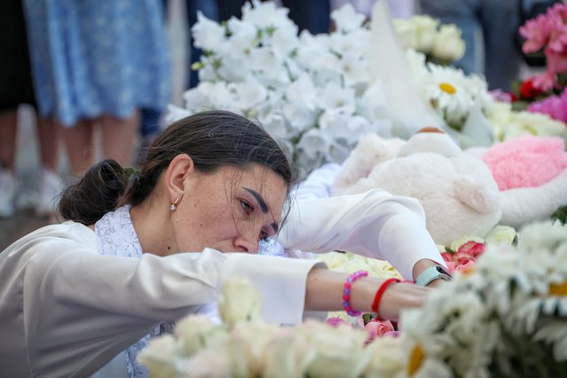 Nadiia, the mother of four-year-old Zlata Rostochyl, who died in hospital on 23 May from wounds sustained in a Russian missile attack, mourns by the coffin of her daughter during a memorial service at Transfiguration Cathedral in Odesa, Ukraine on May 26, 2024. (Photo by Future Publishing/Ukrinform/Getty Images)