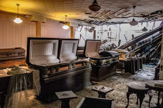 The downstairs area is very dark. The carpet is wet and moldy from the partially collapsed roof. The upstairs floors are soft from the water damage, and a visitor could easily fall through if not careful. (Photo by Abandoned Southeast/Caters News Agency)