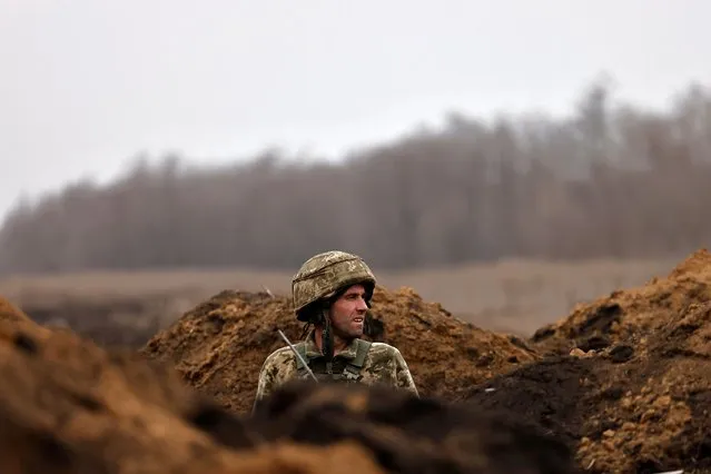 A Ukrainian soldier of the Paratroopers' of 80th brigade watches his surroundings at a frontline position near Bakhmut, amid Russia's attack on Ukraine, in Donetsk region, Ukraine on March 16, 2023. (Photo by Violeta Santos Moura/Reuters)