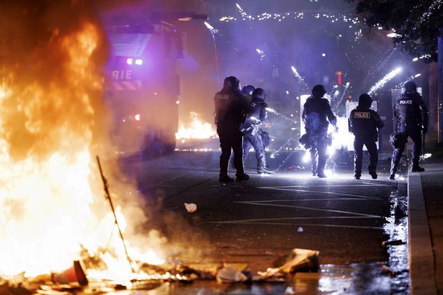 Police officers intervene during the second night of riots following the fatal accident involving a minor on a scooter in Lausanne, Switzerland, 25 August 2025 (issued 26 August 2025). Police said the 17-year-old, who was riding a stolen two-wheeler, died while fleeing from a police patrol. (Photo by Cyril Zingaro/EPA)