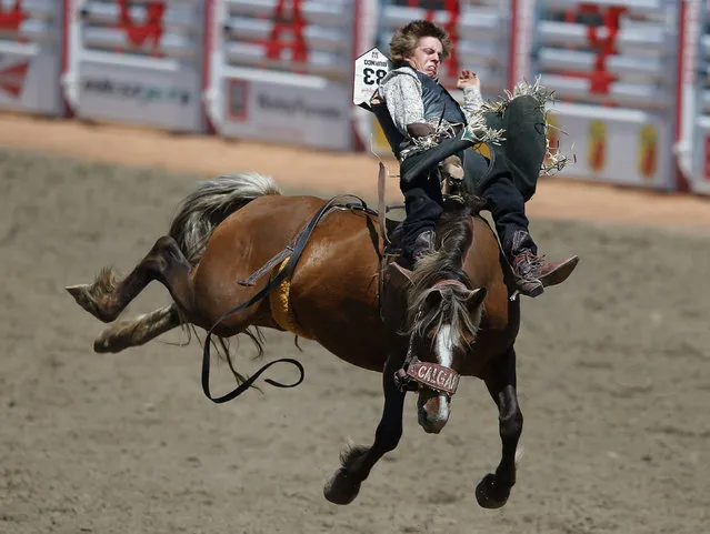 Spur Lacasse of Cochrane, Alberta rides the horse Rebel Warrior in the novice bareback event during the Calgary Stampede rodeo in Calgary, Alberta, July 12, 2014. (Photo by Todd Korol/Reuters)