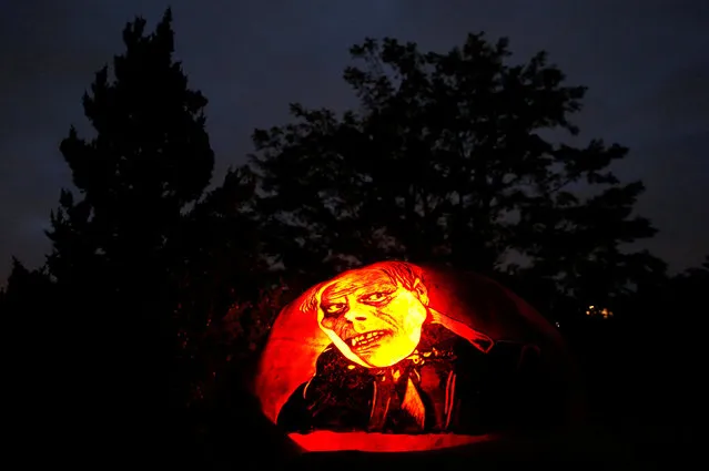 A pumpkin decorated with the image of the Phantom of the Opera is seen at the Night of 1,000 Jack-o'-Lanterns event at the Chicago Botanic Garden in Glencoe, Illinois, U.S., October 21, 2016. (Photo by Jim Young/Reuters)