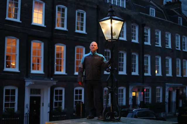 Iain Bell, a gas lamp lighter engineer from British Gas, poses for a picture in Westminster, central London on April 24, 2018. 1,500 gas lamps, some of which are 200 years old, continue to light some secret and beautiful corners of the British capital and are maintained by hand by a five- man team, supervised by engineer Iain Bell. (Photo by Daniel Leal-Olivas/AFP Photo)