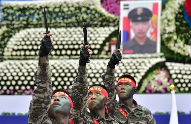 South Korean marines perform a martial art during a ceremony to commemorate the 5th anniversary of North Korea's shelling of Yeonpyeong Island at the War Memorial in Seoul on November 23, 2015.  North Korea warned of "merciless" attacks on South Korean border islands if Seoul stages live-fire drills near the maritime border on the fifth anniversary of Pyongyang's deadly shelling attack. (Photo by Jung Yeon-Je/AFP Photo)